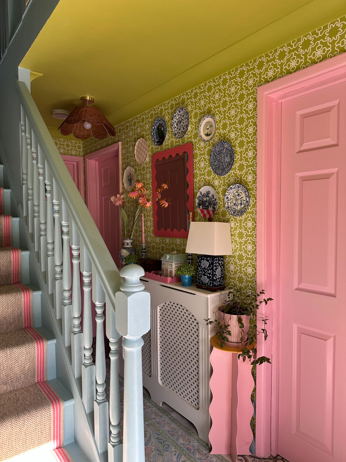 Chartreuse wallpaper in an elegant English hallway