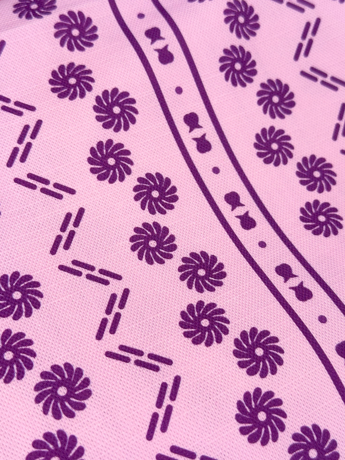 Close up of Debrecen Border heritage fabric in purple and violet colours designed by Reka Thornton 